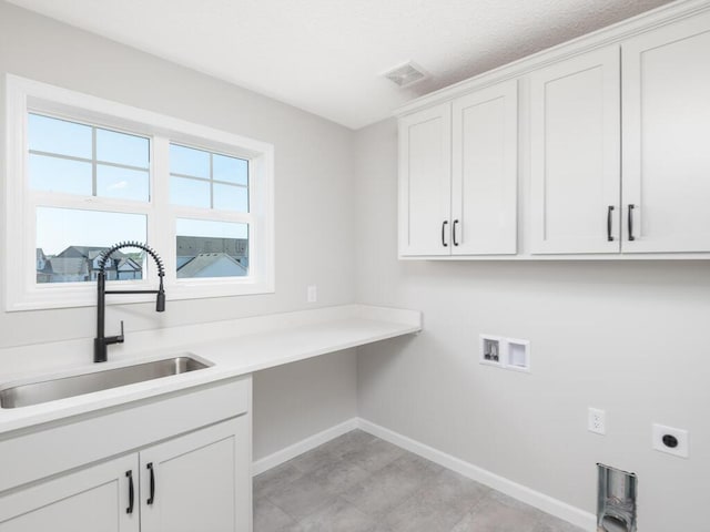 clothes washing area featuring hookup for an electric dryer, sink, washer hookup, and cabinets