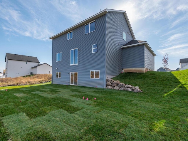 rear view of house featuring a lawn