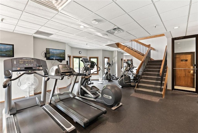 workout area with a paneled ceiling