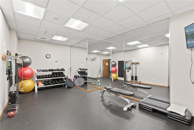 gym with a paneled ceiling