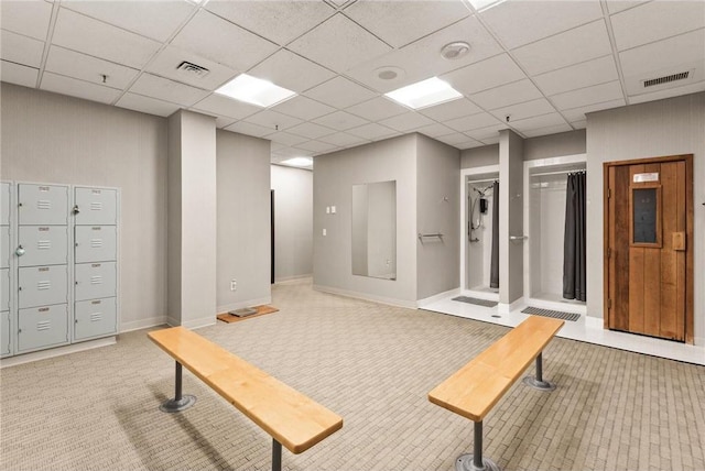 interior space featuring elevator, carpet flooring, and a paneled ceiling