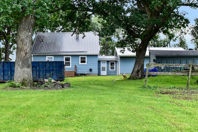 back of property featuring a lawn