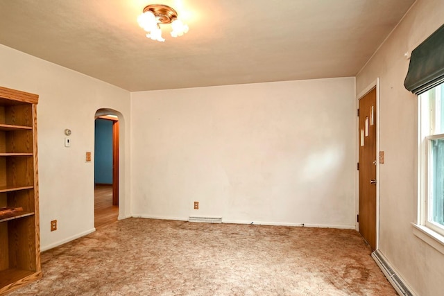 interior space featuring carpet floors, baseboard heating, and plenty of natural light