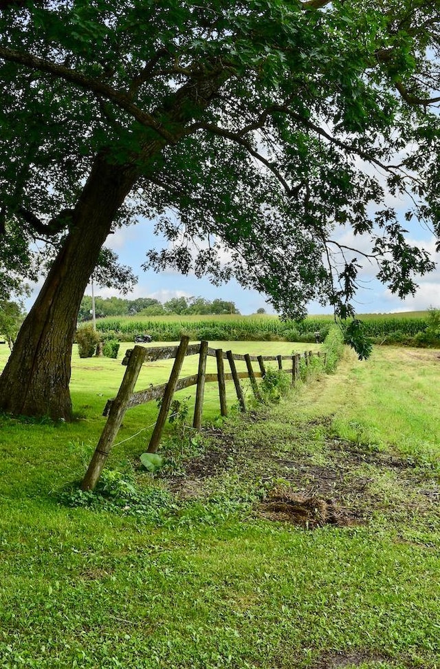 surrounding community featuring a yard and a rural view