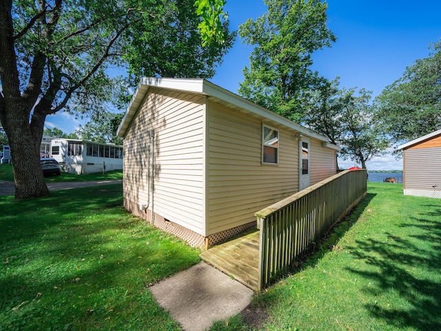 view of side of home with a yard