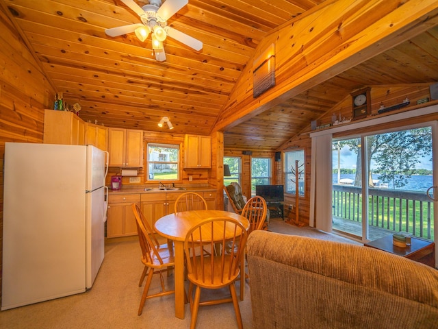 dining area featuring ceiling fan, sink, vaulted ceiling, and wooden ceiling