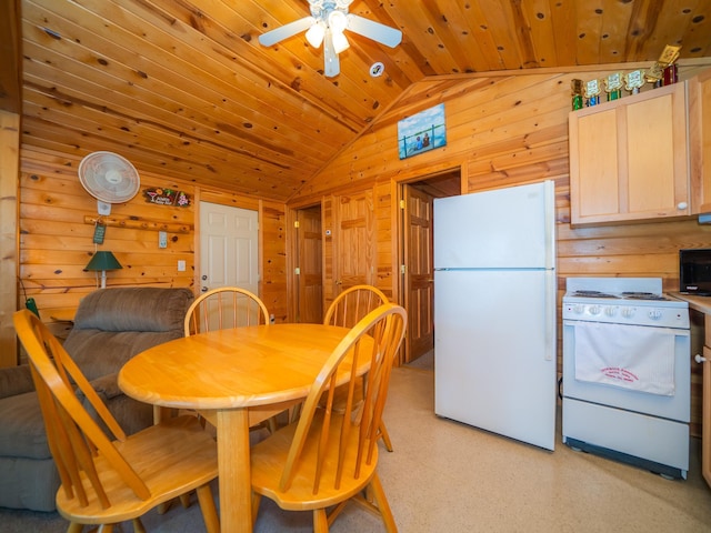 dining room with vaulted ceiling, wood walls, wood ceiling, and ceiling fan