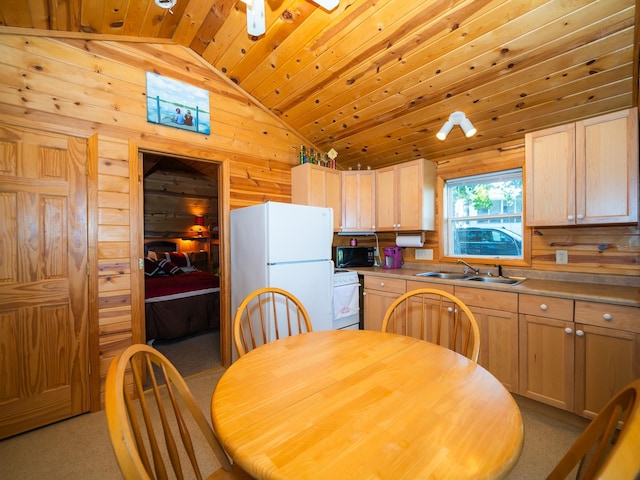 carpeted dining room featuring vaulted ceiling, wooden walls, ceiling fan, sink, and wooden ceiling