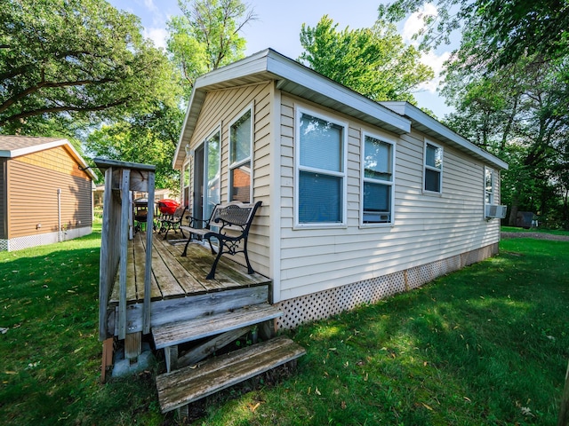 view of side of property featuring a lawn and a deck