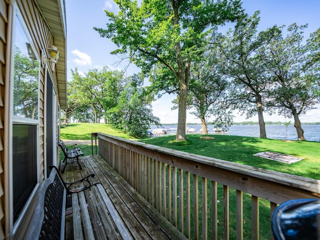 wooden deck featuring a yard and a water view