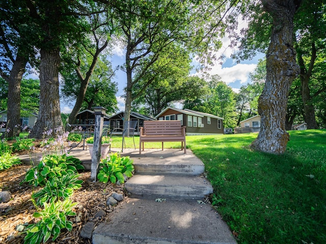 view of home's community featuring a lawn