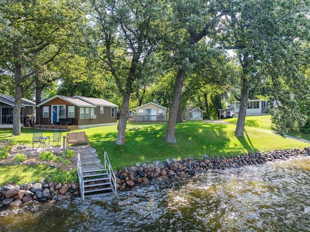 exterior space featuring a water view and a yard