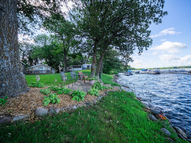 view of yard featuring a patio and a water view