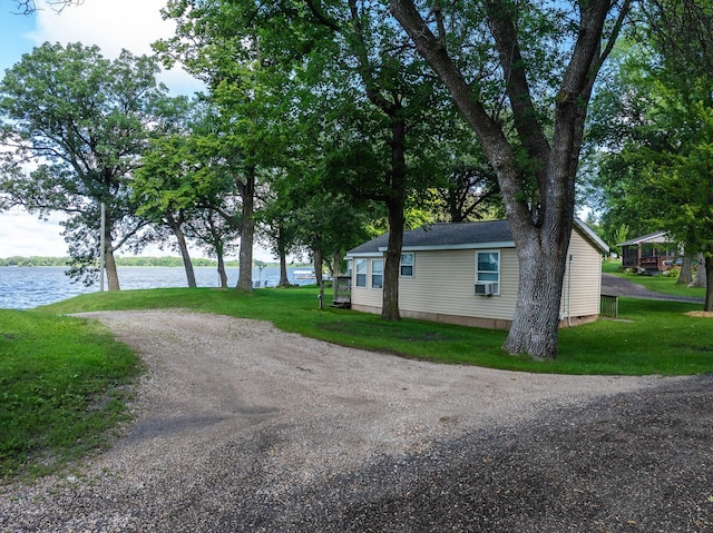 exterior space with a yard and a water view