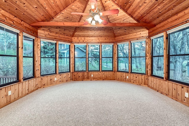 unfurnished sunroom featuring carpet floors, vaulted ceiling, and a wealth of natural light