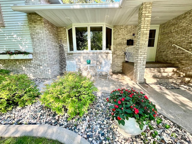 view of exterior entry with a patio