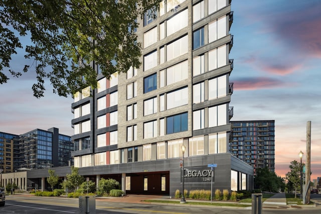 property at dusk with a city view