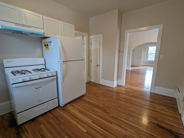 kitchen with white appliances, white cabinets, wood-type flooring, and under cabinet range hood