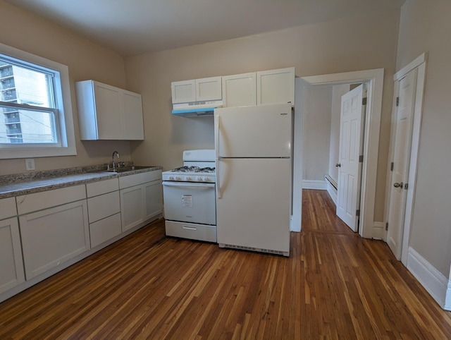 kitchen featuring under cabinet range hood, a sink, white appliances, white cabinets, and dark wood-style flooring