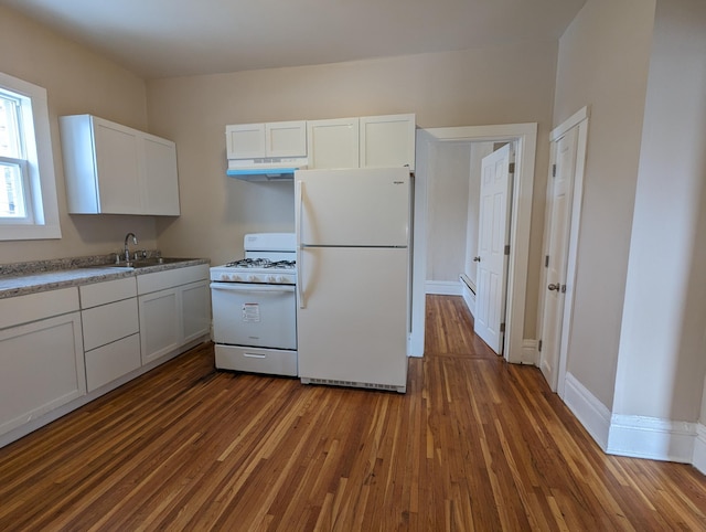 kitchen with white appliances, dark wood-style flooring, a sink, white cabinets, and under cabinet range hood