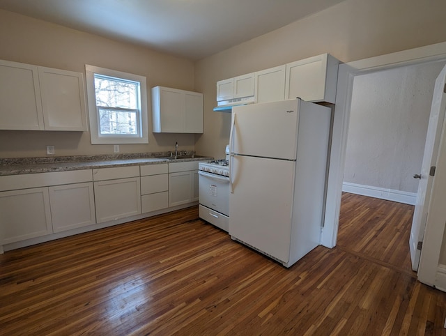 kitchen with dark wood-type flooring, under cabinet range hood, white cabinets, white appliances, and a sink