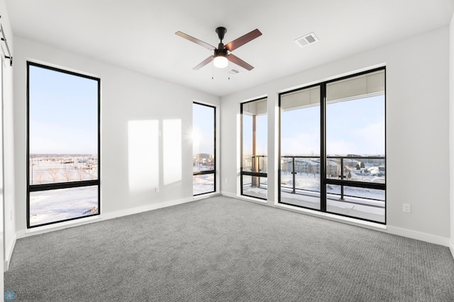 unfurnished room with carpet and ceiling fan