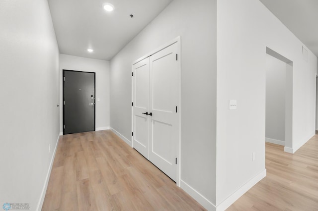 corridor with light wood-type flooring