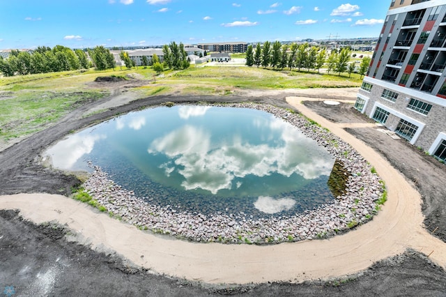 view of swimming pool featuring a water view