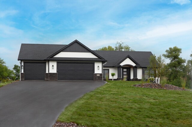 view of front facade featuring a garage and a front lawn