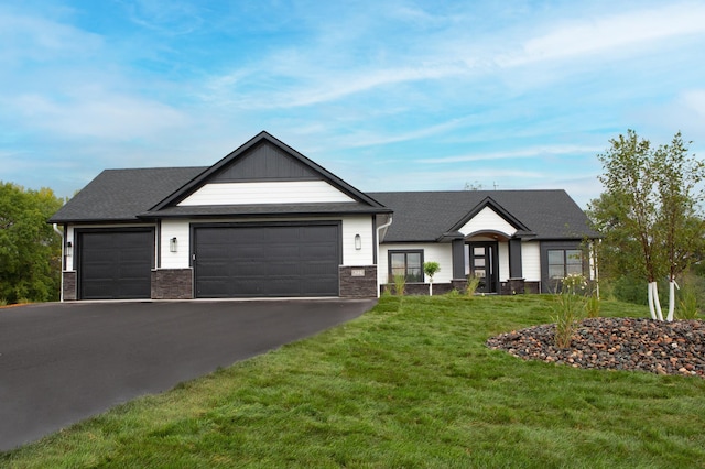 view of front of home with a garage and a front lawn