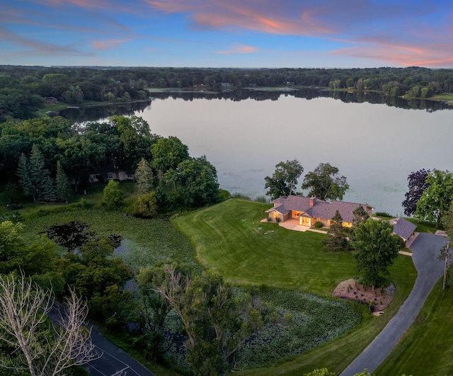 aerial view at dusk with a water view