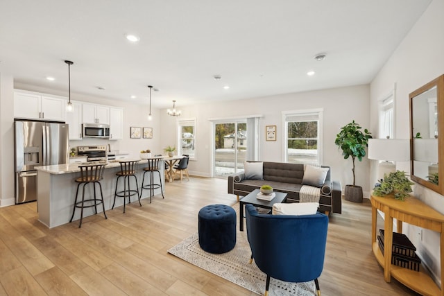 living room featuring light hardwood / wood-style flooring and a chandelier