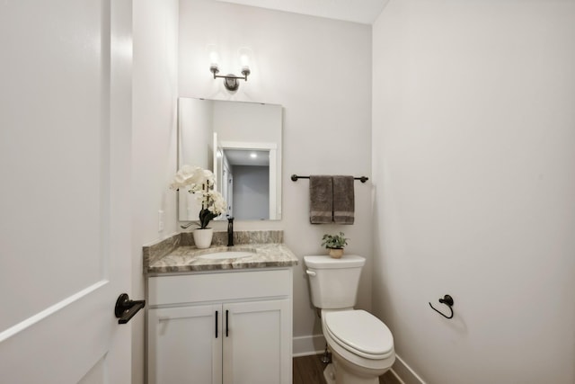 bathroom featuring toilet and vanity