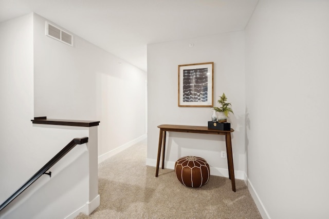 hall featuring light colored carpet