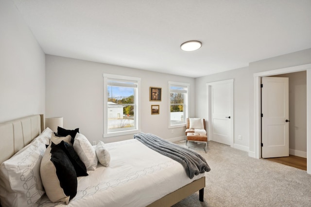 bedroom featuring light colored carpet