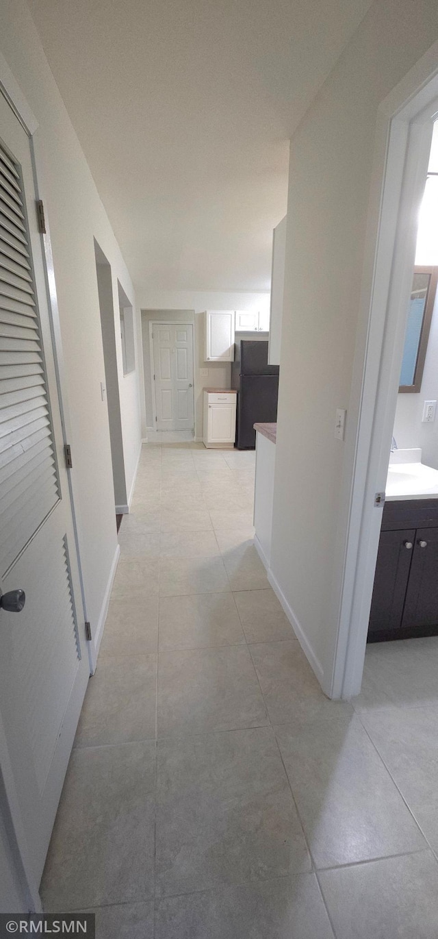 corridor featuring light tile patterned floors