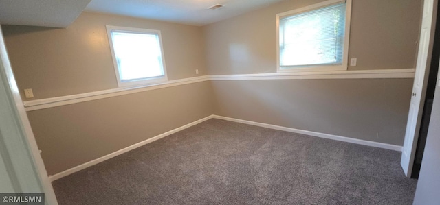 carpeted empty room with a healthy amount of sunlight