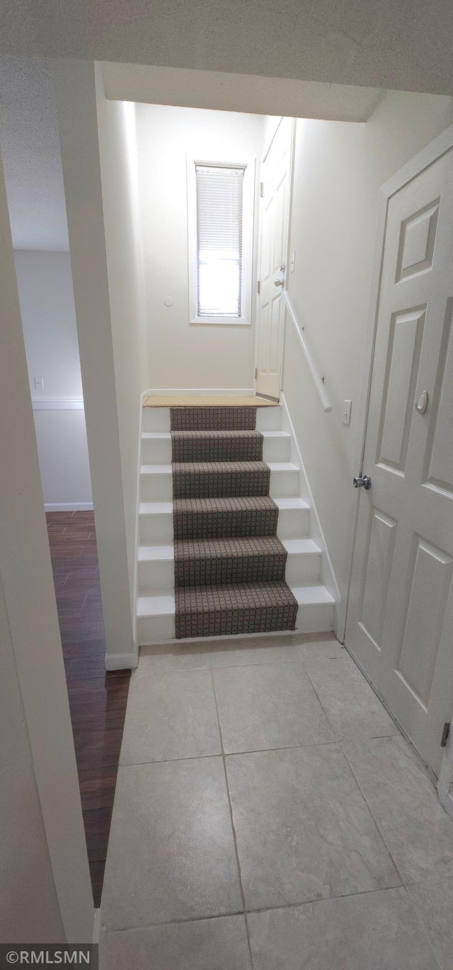 staircase featuring light hardwood / wood-style flooring