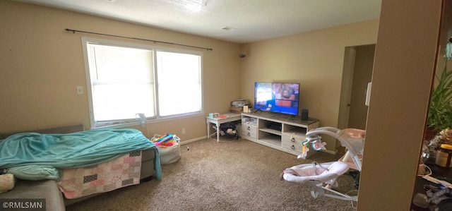 playroom with a textured ceiling and carpet