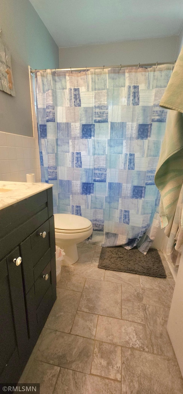 bathroom with tile patterned floors, vanity, and toilet