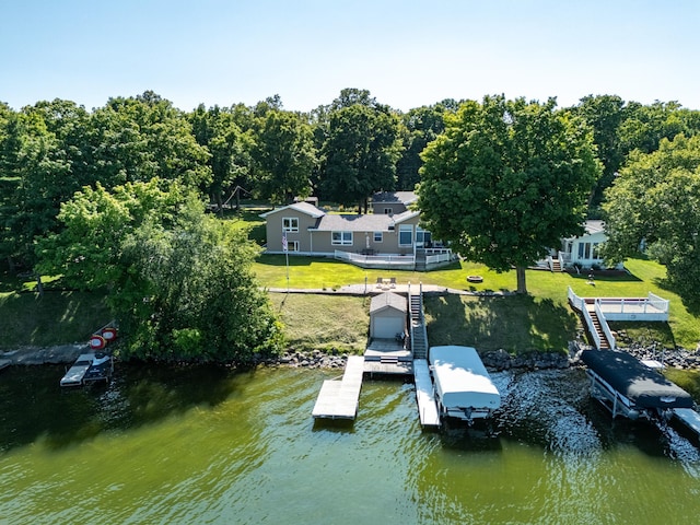 view of dock featuring a water view and a lawn