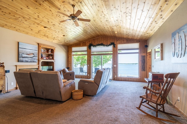 living room featuring ceiling fan, lofted ceiling, carpet flooring, and wood ceiling