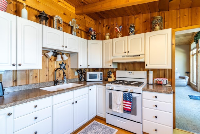 kitchen featuring wood ceiling, white cabinetry, beam ceiling, white appliances, and sink