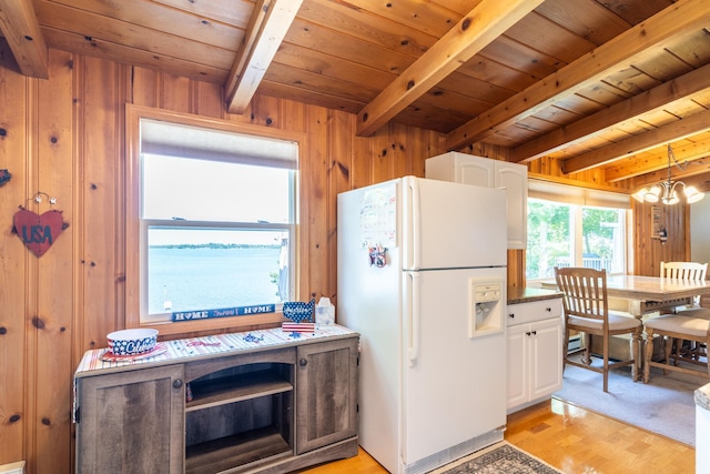 kitchen with light hardwood / wood-style flooring, wooden ceiling, refrigerator, and white cabinetry