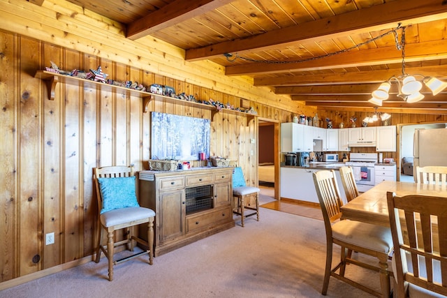 dining space featuring wooden walls, light colored carpet, an inviting chandelier, and wood ceiling