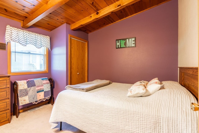 carpeted bedroom featuring lofted ceiling with beams and wood ceiling