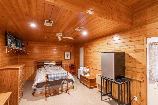 bedroom featuring ceiling fan, wood walls, carpet flooring, and wooden ceiling