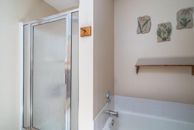 bathroom with a tub to relax in