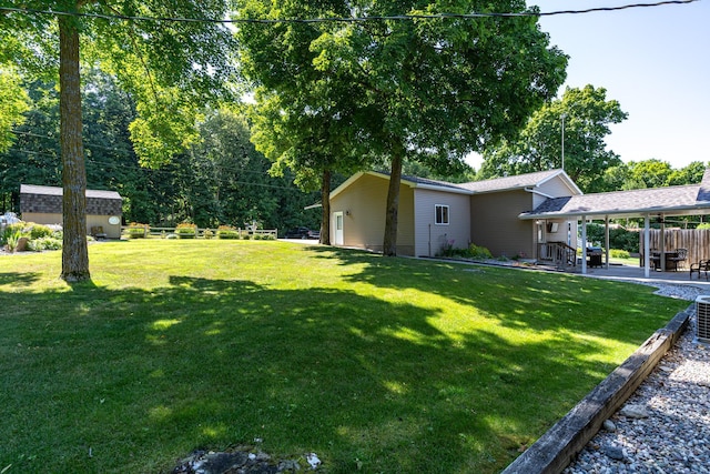 view of yard with an outbuilding and a patio area