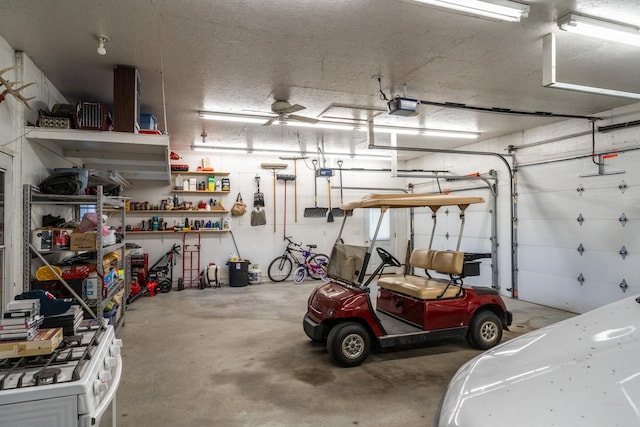 garage with ceiling fan and a garage door opener